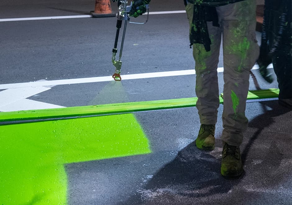 Greenway crew spray-applying MMA pavement markings